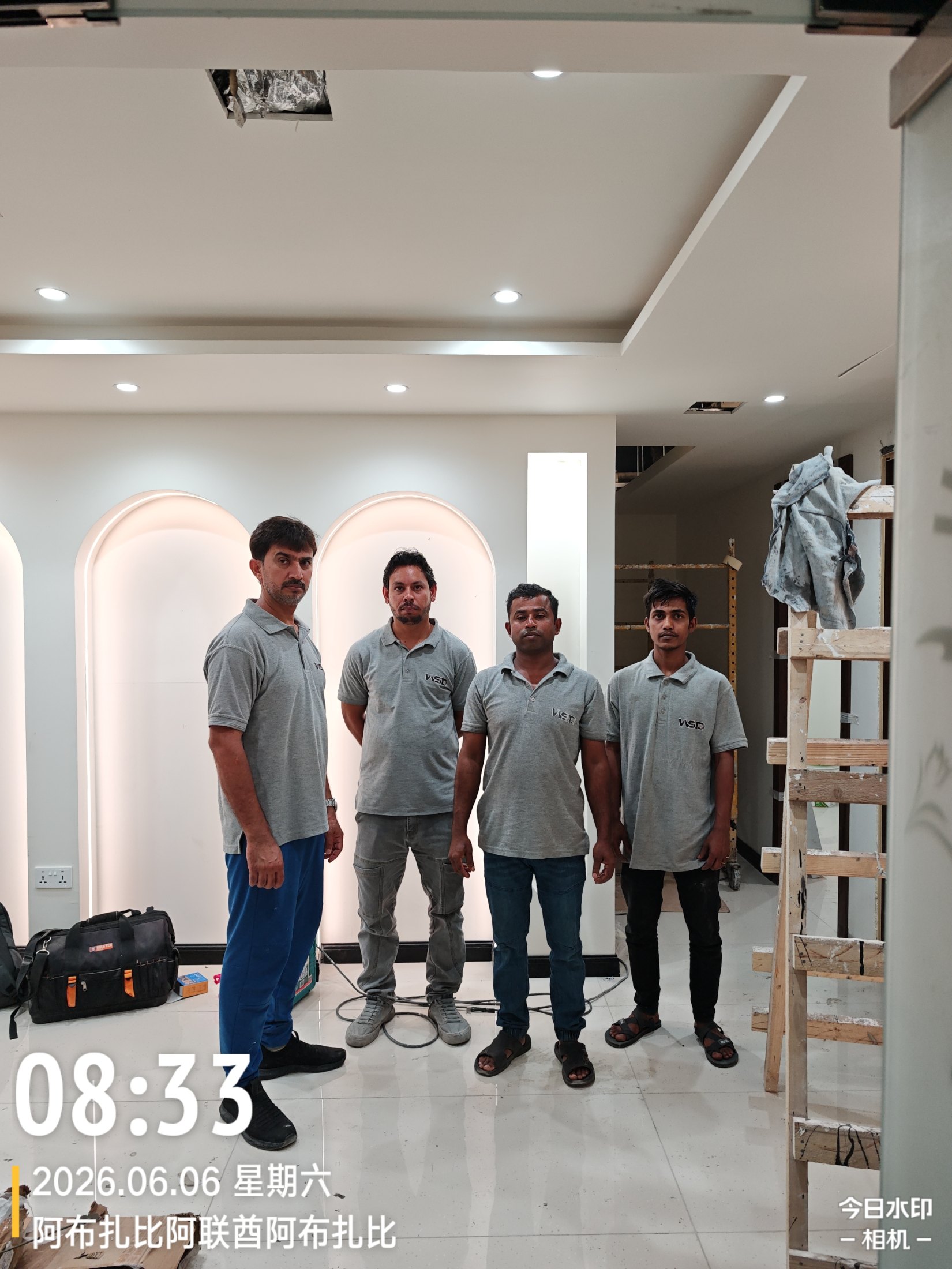 Four WSD team members in matching company work shirts at the HANA SPA interior fit-out site in Abu Dhabi