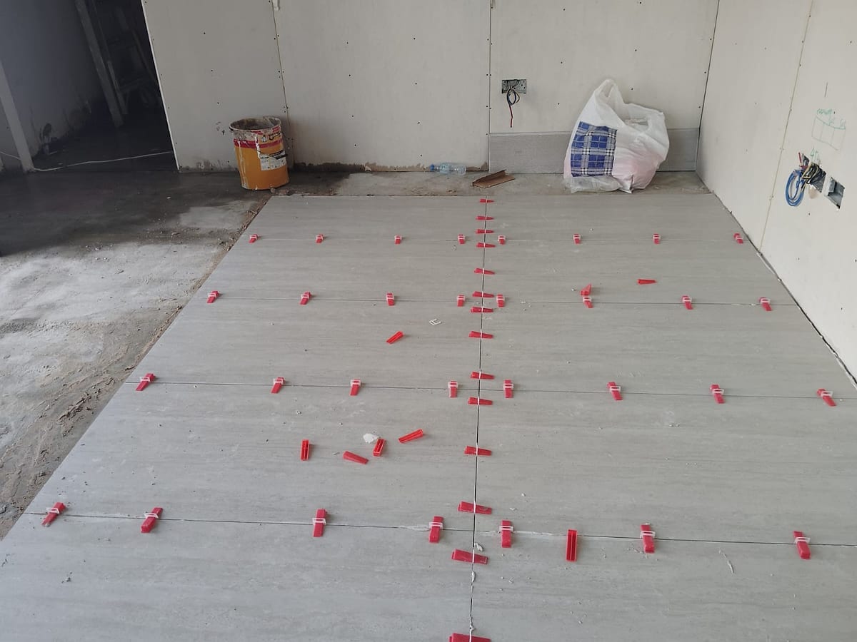 Car showroom tile setting and floor finish coordination during fit-out in Abu Dhabi
